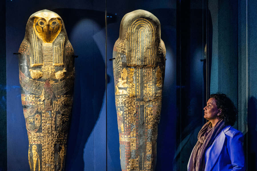 Woman walking past coffins